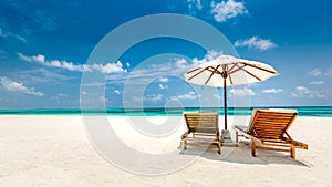 Beautiful Maldives island beach landscape. Luxury resort with chairs and umbrella for summer vacation and holiday background