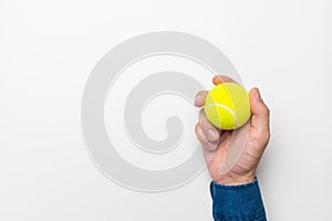 beautiful male hand holding tennis ball on white background mockup, sport shop banner