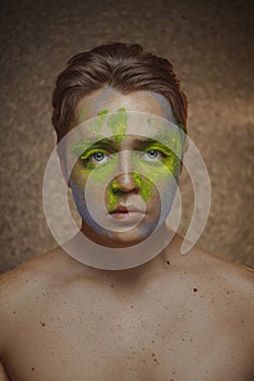 Beautiful male portrait with paint map on his face background beauty portrait photoshoot