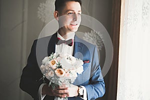 Beautiful man, groom posing and preparing for wedding