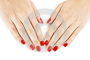 Beautiful manicured woman's hands with red nail polish