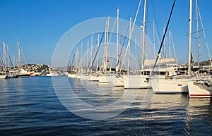 Beautiful marina with sailboats and boats in sunny day on background of blue sky