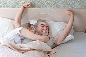 Beautiful married couple lies hugging in bed, life together, relationship in a pair