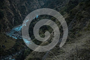 Beautiful Marshyangdi river flowing through a canyon valley underneath rock stairs