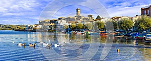 Beautiful Marta village,view with Bolsena lake,boats and old cathedral,Lazio,Italy.