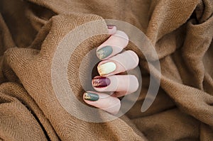 Beautiful matte muted color nails close-up, glittery nail art manicure