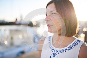 Beautiful mature caucasian woman with brown hair looking off camera