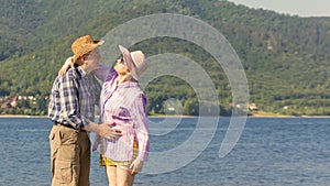 Beautiful mature couple hugging and kissing on a sandy beach on a summer sunny day