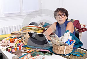 Beautiful mature seamstress using tablet computer