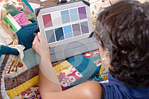 Beautiful mature seamstress using tablet computer