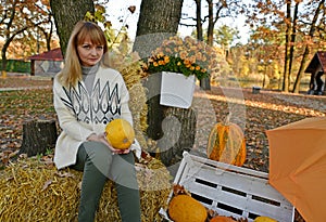 Beautiful mature woman on an autumn walk in the village.