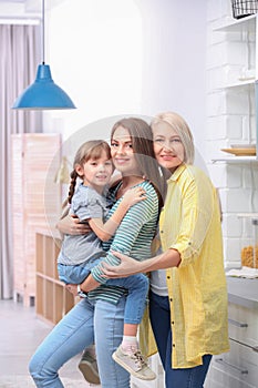 Beautiful mature woman with daughter and grandchild