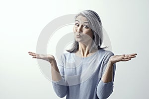 Beautiful mature woman is making funny faces photo