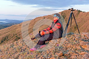 a beautiful mature woman meets the dawn on the Nurali ridge in the southern Urals