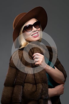 Beautiful mature woman in natural fur coat