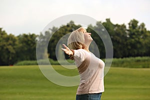 Beautiful mature woman outdoors on summer day