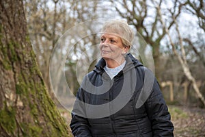 Beautiful mature woman outdoors walking in a woodland