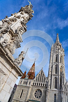 Beautiful Matyas templom Matthias church in Buda castle Budapest with blue sky with trinity statue