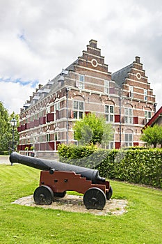 The beautiful Mauritshuis museum with an old gun in the foreground, in the historic fortress town Willemstad, Netherlands