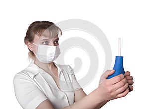 Beautiful medical worker holding a blue enema photo