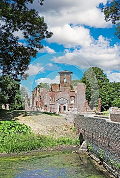 Beautiful medieval brick stone castle ruin, bridge over water moat - Kasteel Bleijenbeek, Afferden, Netherlands