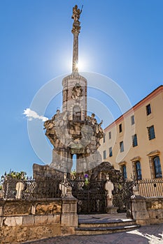 Beautiful medieval column on square in sunlight