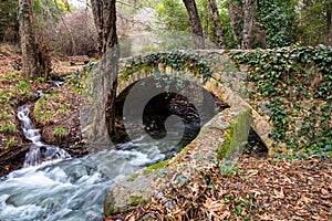 Beautiful medieval stoned bridge with river flowing