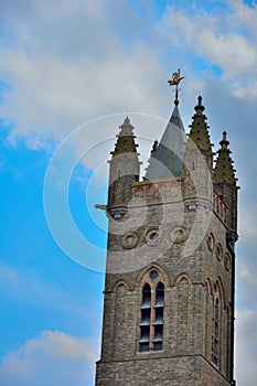 Beautiful medieval tower and ornaments in a clouded sky