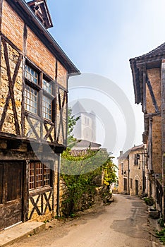 Beautiful medieval village of Saint-Cirq-Lapopie under the fog, in the Lot, in Occitanie, France