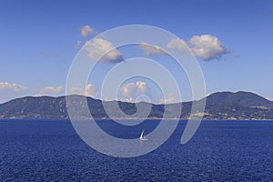 Beautiful Mediterranean coastline. Sailboats in the sunshine: coast of Greece in the Aegean Sea.