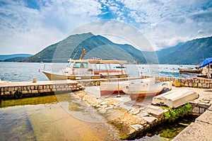 Beautiful mediterranean landscape. Mountains and fishing boats near town Perast, Kotor bay Boka Kotorska, Montenegro
