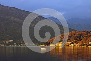 Beautiful Mediterranean landscape. Small seaside village lit by the setting sun. Montenegro, Adriatic Sea, Bay of Kotor