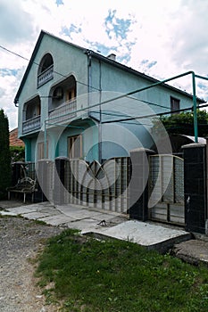 Beautiful metal fence in front of a country house with balconies