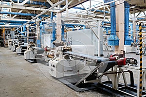 Beautiful metal industrial equipment of a production line at a machine-building plant, a conveyor with machine tools for products.
