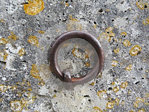Beautiful metallic ring on the old wall to hold animals fixing anchor photo