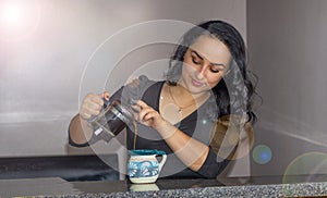 Beautiful Mexican woman serving coffee