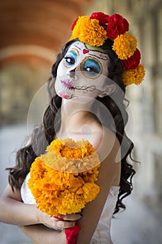Beautiful Mexican woman with wedding dress and makeup Catrina