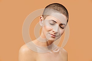 Beautiful mid 30s woman with closed eyes and peaceful facial expression. Photo of attractive caucasian woman with perfect skin.