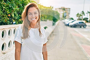 Beautiful middle age hispanic woman smiling happy outdoors