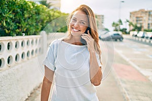 Beautiful middle age hispanic woman smiling speaking on the phone happy outdoors