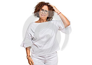 Beautiful middle age mature woman wearing casual clothes and glasses confuse and wonder about question