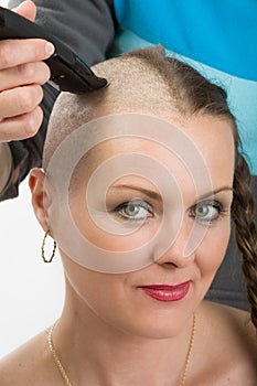 Beautiful middle age woman cancer patient shaving hair