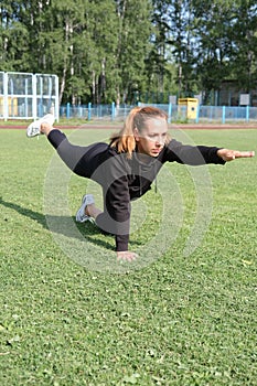 Beautiful middle age woman doing yoga poses outdoors