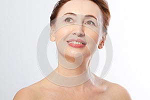 Beautiful middle age woman face close up isolated on white. Collagen and face injections. Plastic surgery. Anti aging concept.