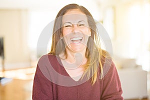 Beautiful middle age woman smiling at home