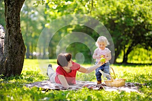 Beautiful middle aged woman and her little grandson having a picnic