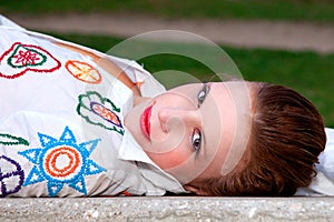 Beautiful middle-aged woman, lying on a garden ben