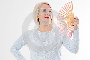 Beautiful middle aged woman with menopause blowing by fan. Hormone replacement therapy and mature woman healthcare. Mid age happy photo
