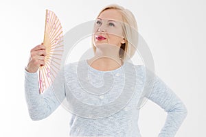 Beautiful middle aged woman with menopause blowing by fan. Hormone replacement therapy and mature woman healthcare. Mid age happy