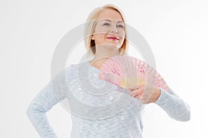 Beautiful middle aged woman with menopause blowing by fan. Hormone replacement therapy and mature woman healthcare. Mid age happy
